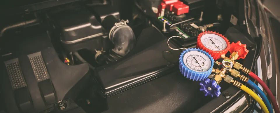 A/C manifold gauges hooked up in an engine bay