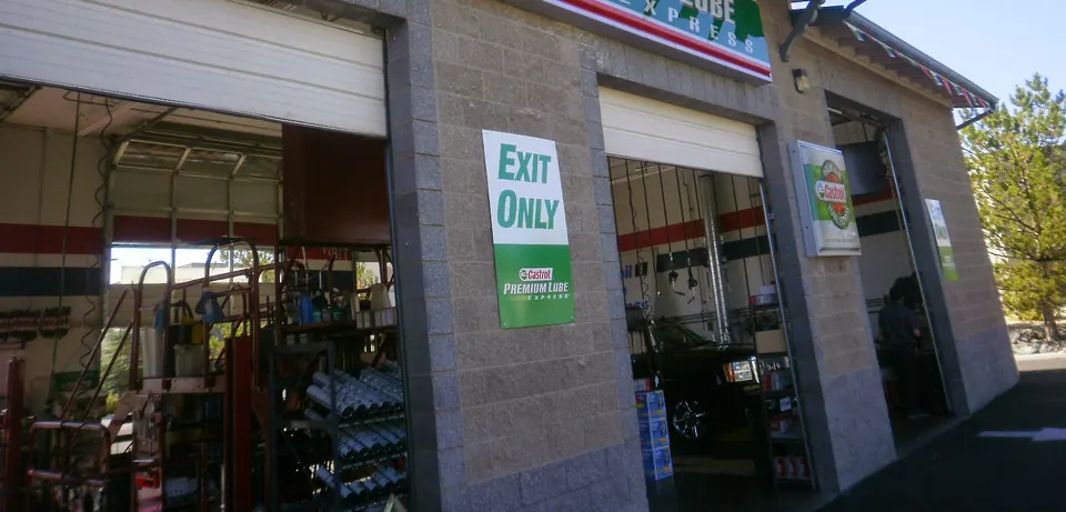 An open bay door at the Carson City service center with shelves of oil inside