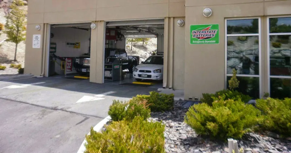 Cars in the open bays at the Reno Northwest service center, landscaping out front