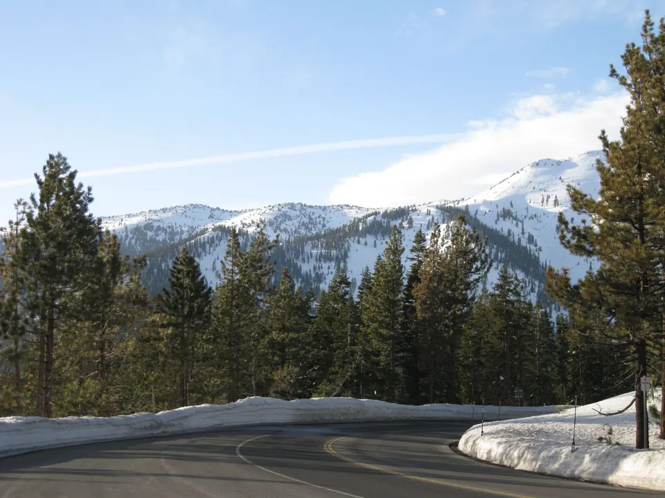 A curving road through pines and snowy peaks near South Lake Tahoe