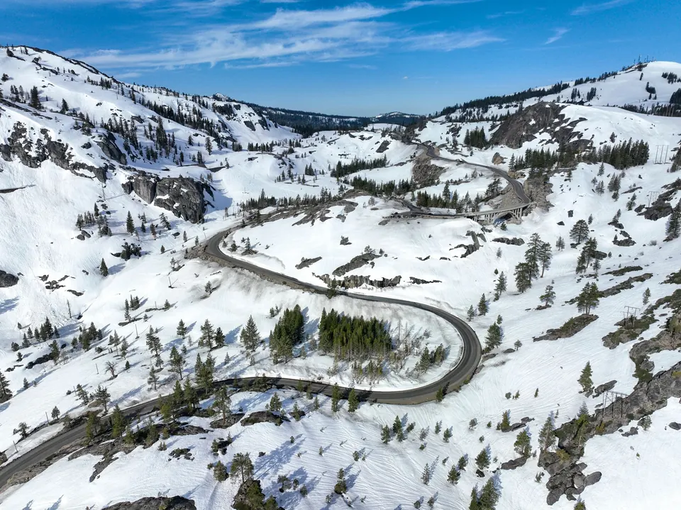 Aerial view of a winding mountain road through snow near Donner Pass