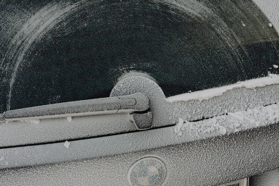 A frosted rear window and wiper on a winter morning